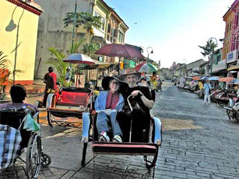 Disabled Travel is faciliated in Malayasia by riding in trishaws