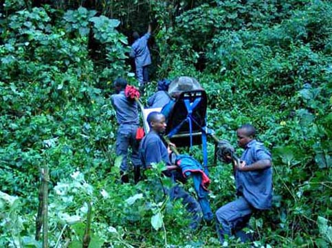 Travel Uganda - Disabled Travelers Guide - Porters carrying Nancy